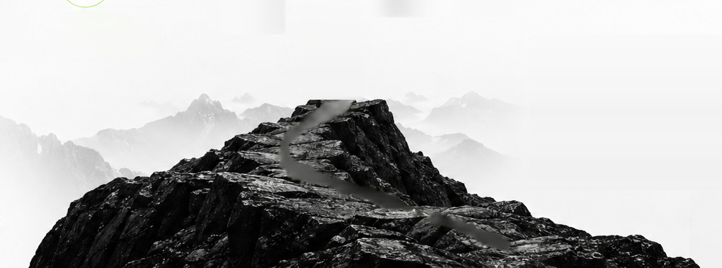 A dark rocky summit above a sea of mist